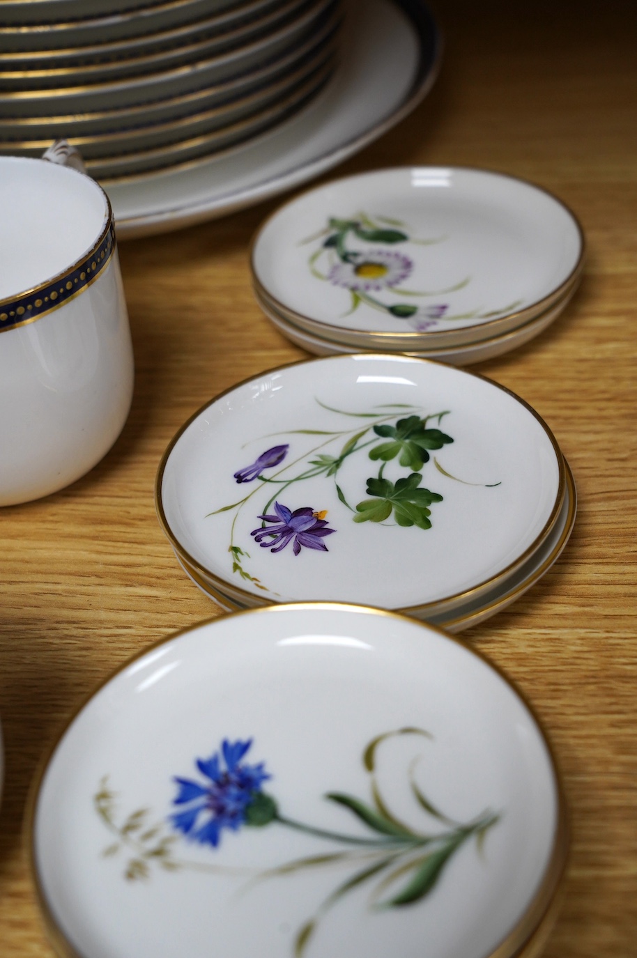 A Royal Worcester blue and gilt crested part tea set together with a set of seven floral Rosenthal miniature porcelain dishes, largest 22cm in diameter. Condition - varies, mostly fair